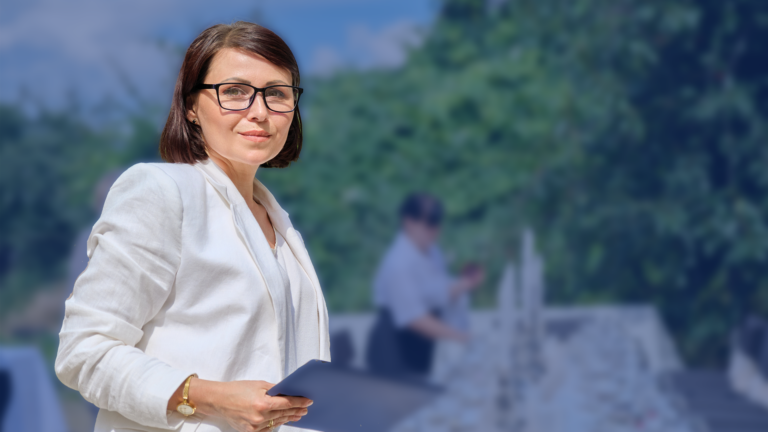 a woman holding a tablet at an outdoor banquet