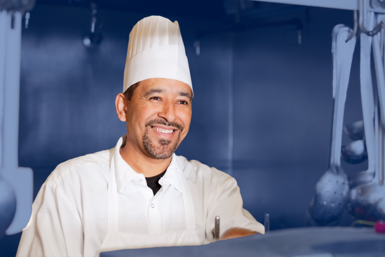 A smiling chef working in a kitchen